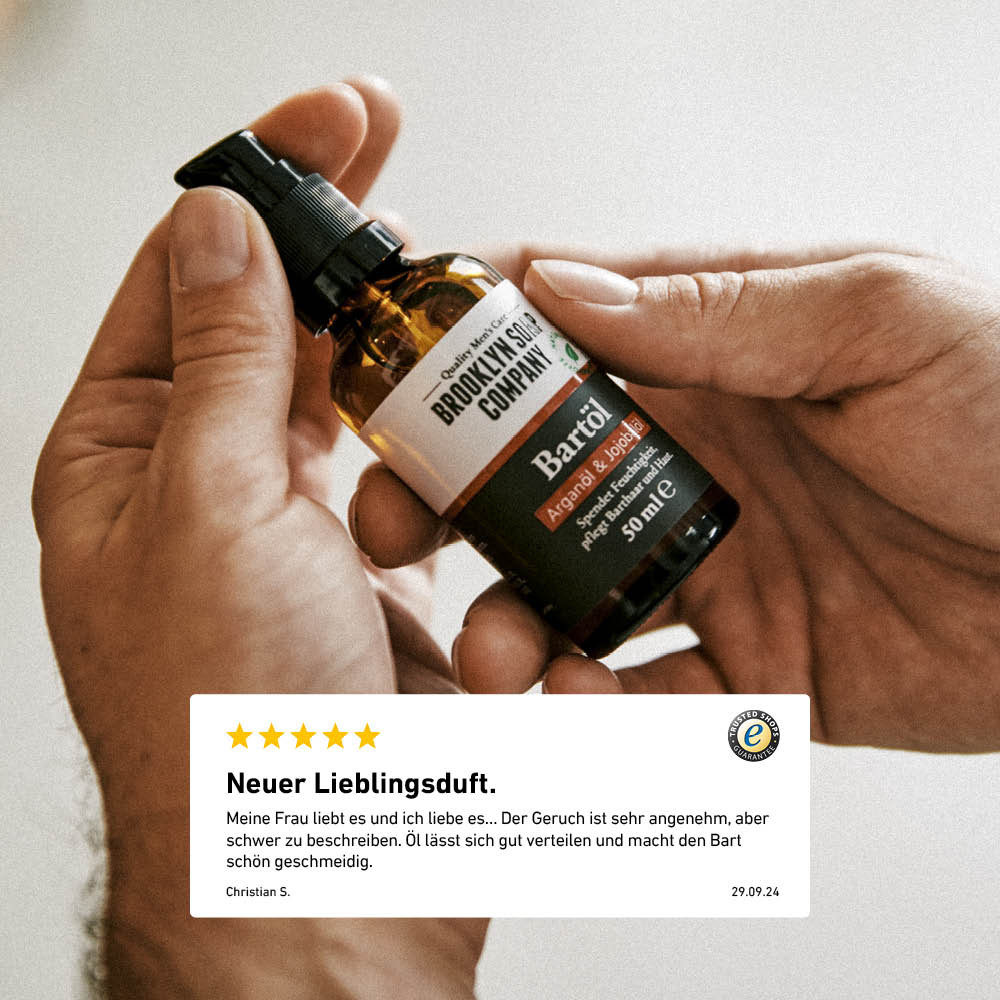 Bartöl-Flasche von Brooklyn Soap Company in der Hand gehalten, mit eingeblendeter 5-Sterne-Bewertung eines Kunden.